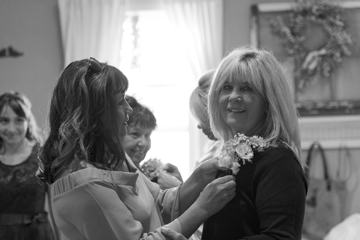 Black and white shot of moms getting ready for wedding