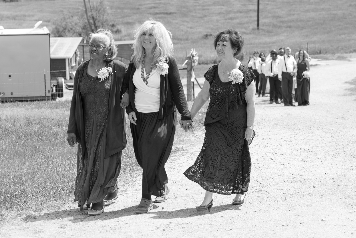 Moms walking hand in hand down the aisle